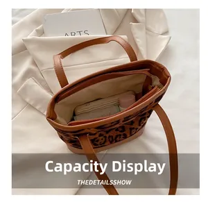 Spacious interior of leopard print tote bag with zipper pocket and ample storage space