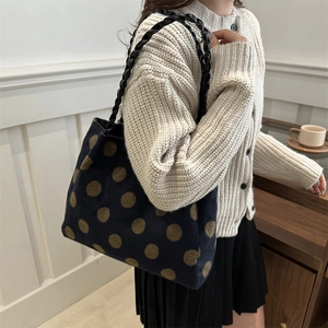 Winter casual tote bag with gold polka dots and woven black handles for daily fashion