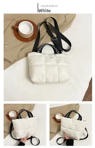 Detail of quilted purple tote bag with GENTLEWOMAN strap and adjustable crossbody belt