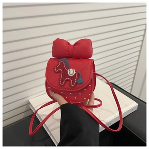 Detail of red crossbody bag for girls with quilted bow and embroidered pony patch