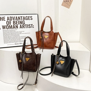Retro polished leather tote bag in brown and black with gold logo and shoulder strap
