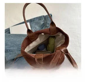 Macro view of brown suede tote bag interior showing large capacity for daily items
