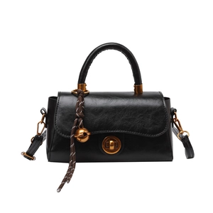 Classic black vintage small square handbag with top handle and decorative bell pendant