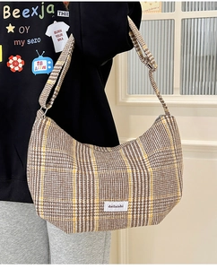 Detail view of the brown and white plaid wool Hobo bag with adjustable shoulder strap