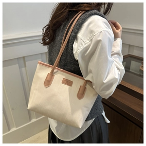 Close-up of the large canvas tote bag with brown leather trim and FASHION&BAG logo