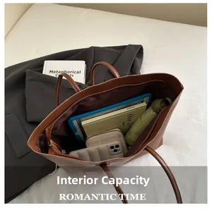 Top view of the spacious interior of the brown tote bag showing daily essentials