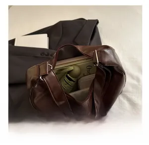 Spacious interior of dark brown tote bag showing capacity for a notebook and umbrella