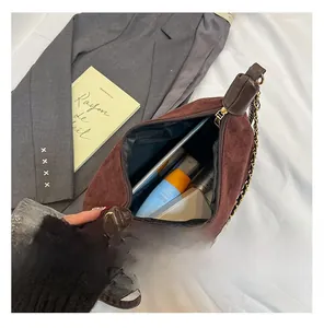 Internal view of brown suede hobo bag showing large storage capacity for daily essentials