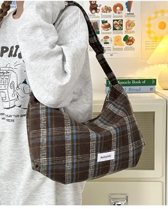 Close-up of brown plaid dumpling bag with vintage blue and white check patterns