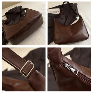 Detail of dark brown vintage hobo bag with adjustable silver buckle and metal zipper