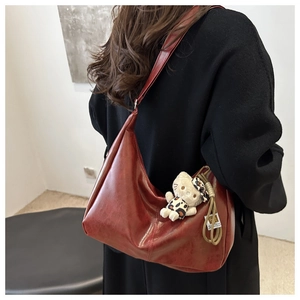 Detail of dark red faux leather Hobo tote bag with stylish leopard Hello Kitty charm