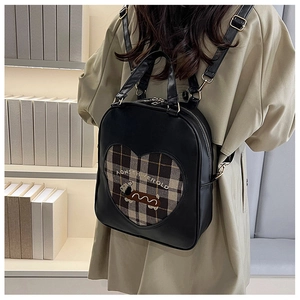 Detail of adjustable PU leather straps on a vintage puppy pattern backpack for women