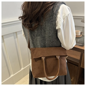 Brown textured suede tote bag shown in a stylish shoulder-carry style on a model
