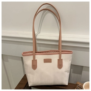 Detail of minimalist tote bag with wave texture fabric and pink faux leather trim