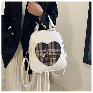 Detail of white PU backpack featuring heart pattern and cute cartoon dog embroidery