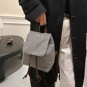 Gray wool backpack for women featuring brown leather drawstring and top handle
