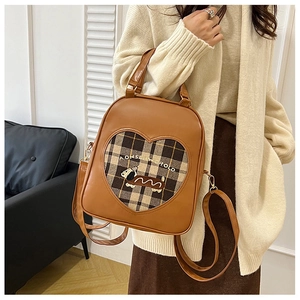 Brown faux leather backpack featuring heart-shaped plaid patch and dog embroidery