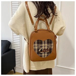 Close-up of brown faux leather backpack with heart window and dachshund embroidery