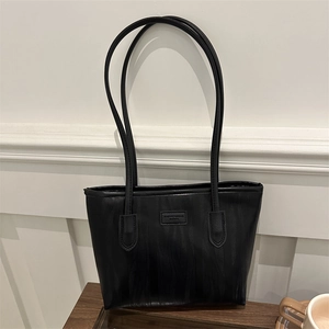 Large black tote bag with ripple texture and shoulder straps for daily commuting