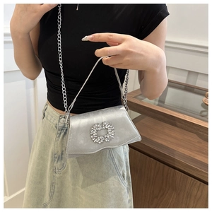 Silver satin evening bag with a square rhinestone buckle and metal chain strap details