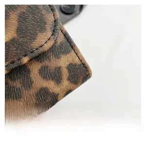 Detailed view of leopard print fabric texture and neat stitching on a square crossbody bag