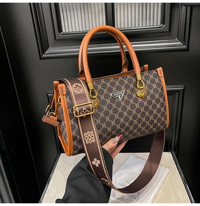 Detail of vintage brown tote bag with geometric pattern and wide jacquard shoulder strap