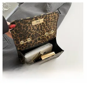 Interior view of leopard print crossbody bag showing capacity for phone and cosmetics