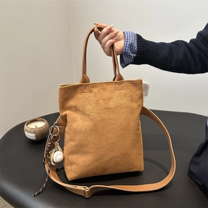 Caramel suede tote bag for women with baseball charm and adjustable shoulder strap