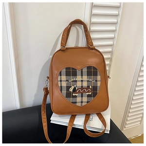 Detail view of vintage dog backpack showing brown PU leather and heart plaid embroidery