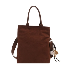 Deep brown suede tote bag with baseball charms and adjustable shoulder strap