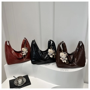 Detailed view of three large HOBO tote bags in brown, black and dark coffee PU leather
