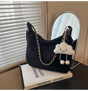 Black suede hobo bag featuring a chunky gold chain strap and cute cloud charm detail