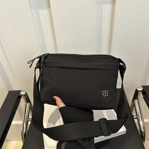 Minimalist black casual crossbody bag with flower logo and adjustable wide strap