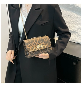 Detail of trendy leopard print chain bag with golden square metal twist lock on purse