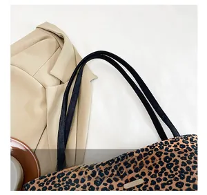 Detailed macro view of leopard print tote bag with comfortable slim black shoulder straps
