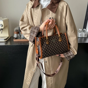 Retro monogram tote bag with brown leather trim and wide canvas shoulder strap for women