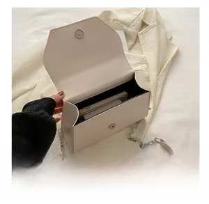 Interior view of the cream shoulder bag showing capacity for phone and wallet