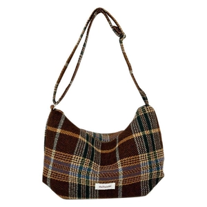 Brown plaid tweed dumpling bag with adjustable shoulder strap and minimalist design