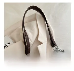 Detail shot of vintage brown suede tote bag with stylish silver metal chain and leather straps