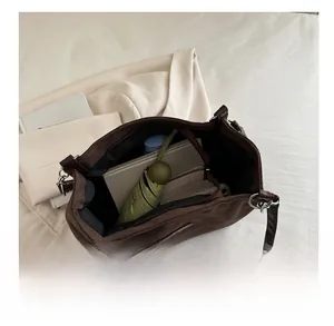 Detail view of large dark brown suede tote bag showing spacious inner storage capacity