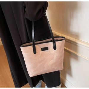 Detailed macro view of the minimalist light pink tote bag with brand logo and matte finish