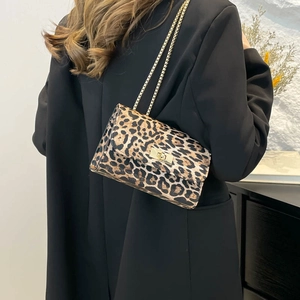 Fashionable leopard print shoulder bag with gold chain strap and metal turn-lock closure
