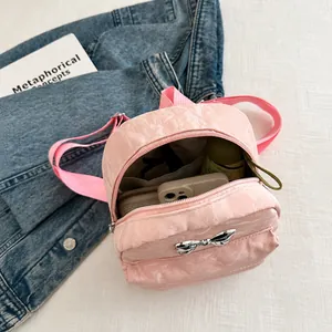 Detail of pink mini backpack with bow and interior space for phone and tissue