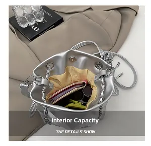 Spacious interior of silver bucket bag showing storage for wallet and cosmetics