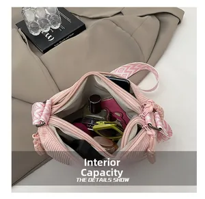 Detailed interior of pink corduroy crossbody bag showing large capacity for essentials