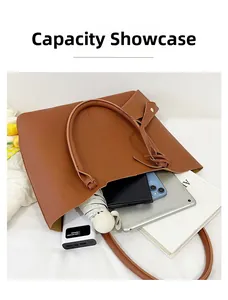 Top-down view of a spacious brown tote bag interior filled with everyday commute essentials