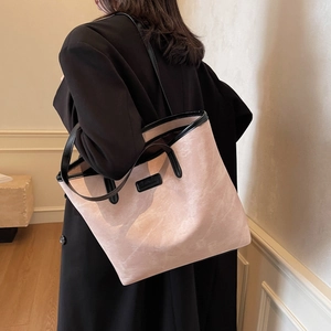 Large capacity tote bag in dusty pink with black leather trim and vintage texture