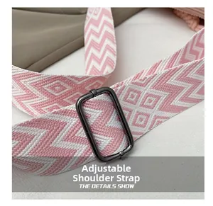 Macro view of adjustable woven shoulder strap with pink and white geometric patterns