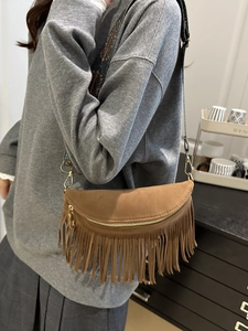 Brown suede tassel crossbody bag with ethnic patterned wide strap and gold hardware