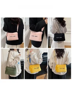 Detail view of corduroy tote bags in multiple colors featuring adjustable striped shoulder straps